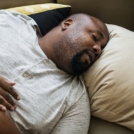 Man in bed snoring before sleep apnea therapy