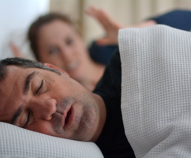 man with sleep apnea sleeping with partner