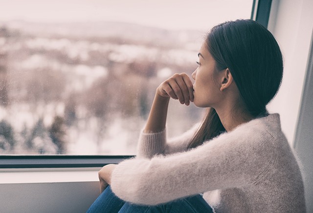 woman looking out the window 