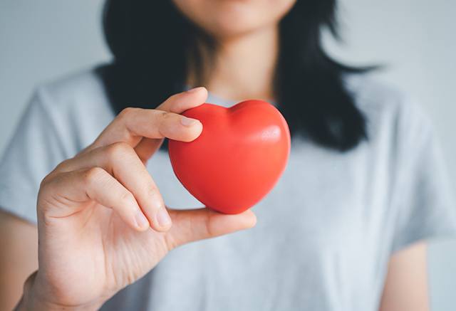 woman holding red heart 