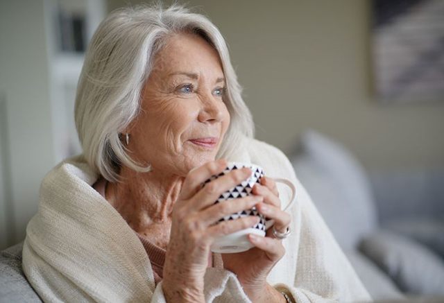 Elegant senior woman sipping coffee