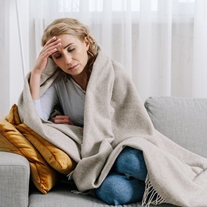 a woman covering her ears due to her partner snoring