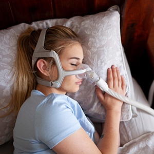 woman sleeping with sleep apnea machine