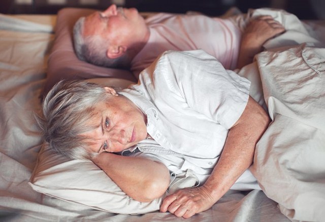 a woman worried while resting with her husband