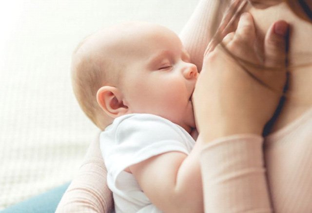 Close-up of baby peacefully breastfeeding