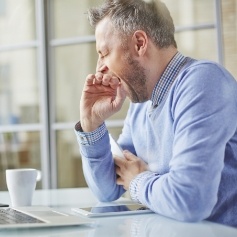 Man yawning before better sleep thanks to sleep apnea therapy