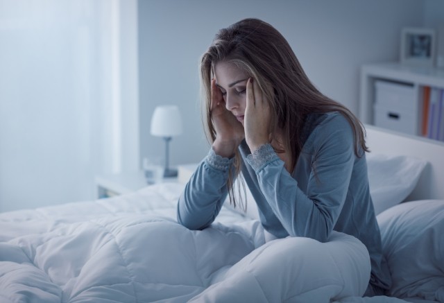 Woman waking feeling tired due to sleep apnea therapy