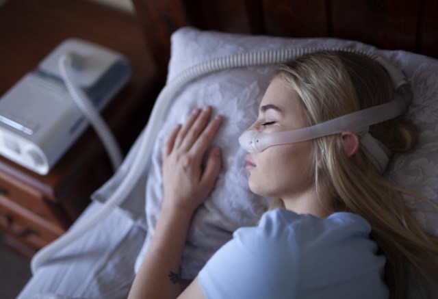 Woman resting with CPAP nasal mask