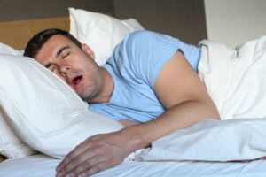 Person with obstructive sleep apnea snoring loudly