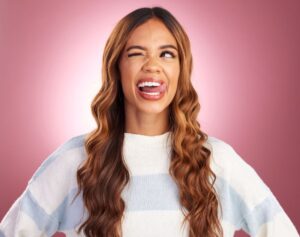 Woman squinting and sticking out her tongue