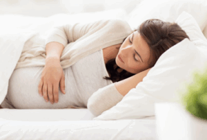 Pregnant woman resting peacefully in bed