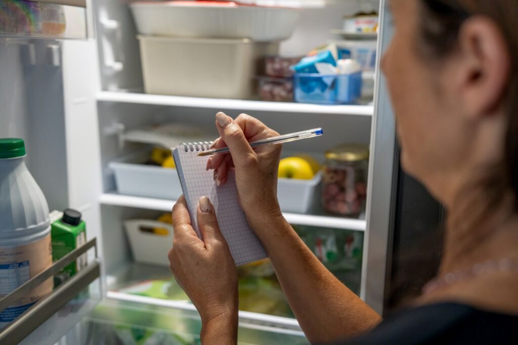 A woman writing a grocery list