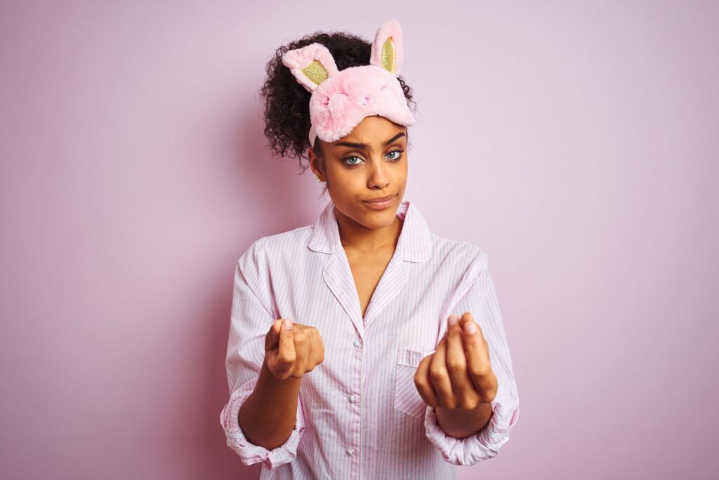 A tired woman wearing a sleep mask
